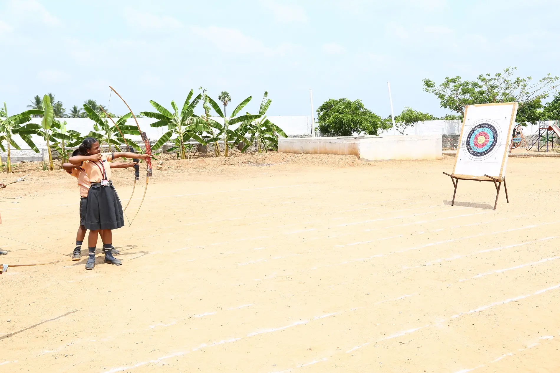 Student practising archery on the school ground